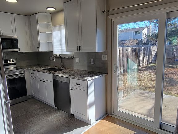 Sliding glass door opens to fenced backyard.