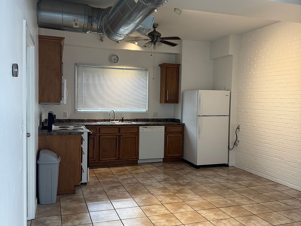 Kitchen open to living area. All freshly painted white walls.