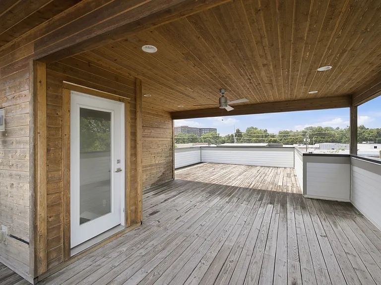 doorway leading to the deck which is partially covered in the middle and the ends are open.