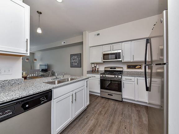 Kitchen with stainless steel appliances, granite counters, and white cabinets.