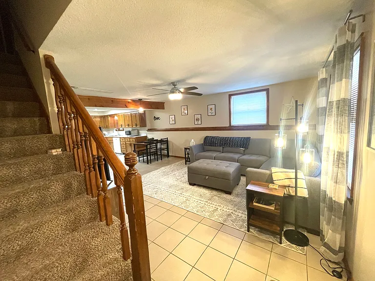 Stairs going to 2nd floor and looking out onto living area