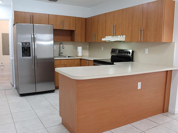 Kitchen with electric stovetop and oven.