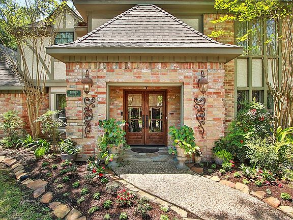 Winding stone enhanced walkway offers Gracious formality with this elegant Brick covered porch. Eye catching gardens highlighted with color and deciduous growth. Roof 2001 with 30 year shingles.