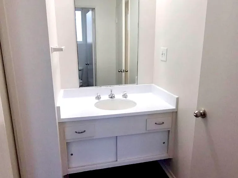 Main bedroom vanity and sink. (Lights on)