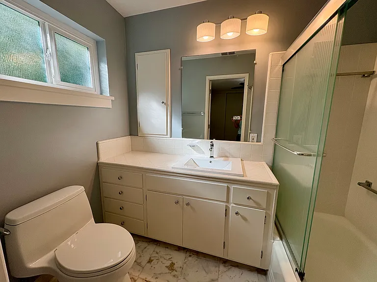 Bathroom with shower over tub