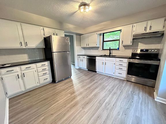 Brand new kitchen featuring all new stainless appliances, granite countertops, backsplash, flooring and updated cabinets.