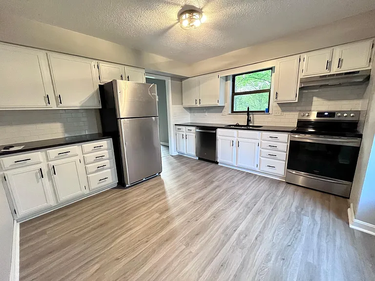 Brand new kitchen featuring all new stainless appliances, granite countertops, backsplash, flooring and updated cabinets.