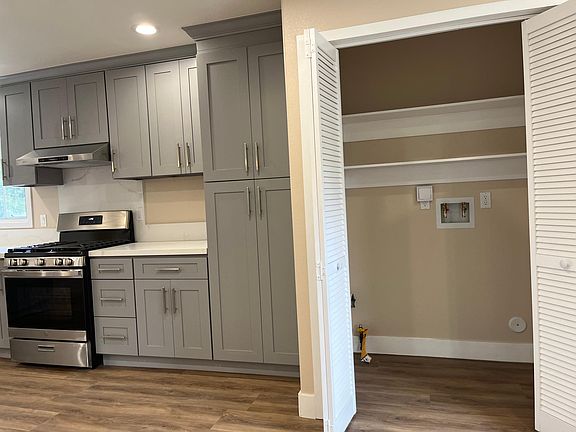 Inside laundry room with bi fold doors.