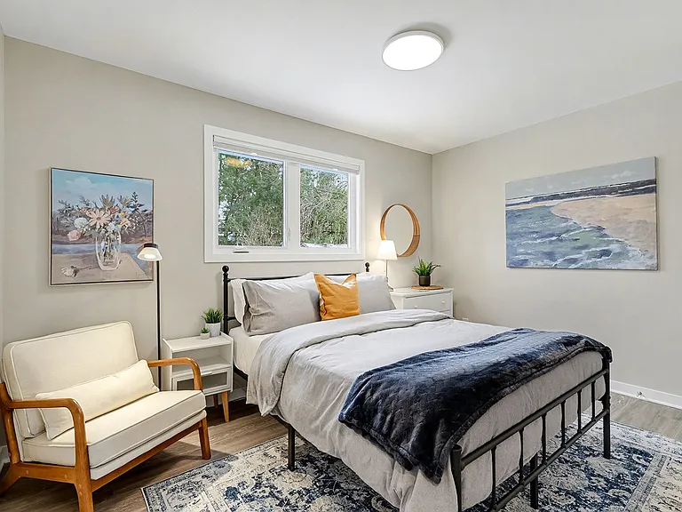 Second cozy bedroom with Queen bed designed to provide stability for insurance-displaced families in Ottawa.