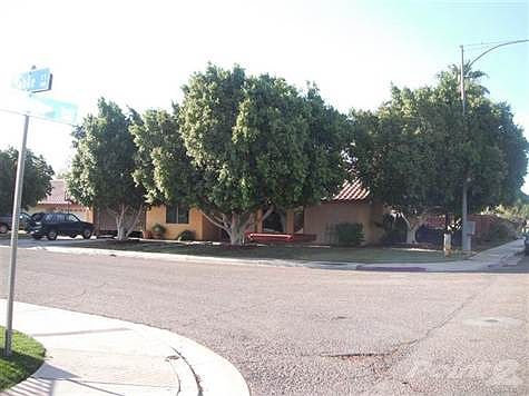 Nice corner home with four bedroom, two bathroom, pool, shade trees and green landscaping at Villa de Oro Subdivision