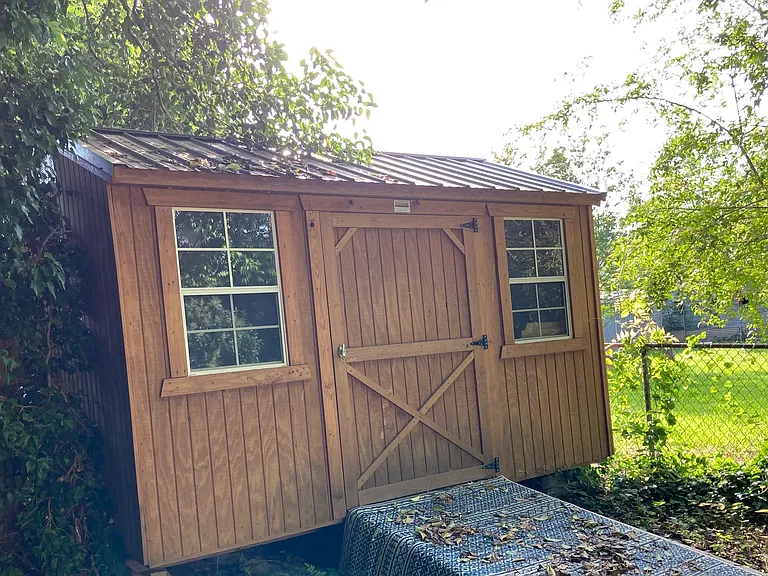 Roomy storage building hidden in back of property.