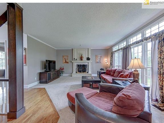 Family Room features a wall of windows and beautiful fireplace.  New carpet/paint.  Open floor plan to the kitchen and eating areas.