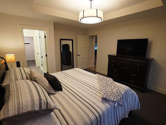 Upper level master bedroom with king-size bed and ensuite bathroom.