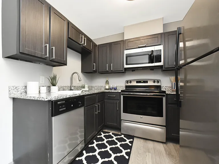 Kitchen with granite counters, stainless appliances, and modern cabinetry