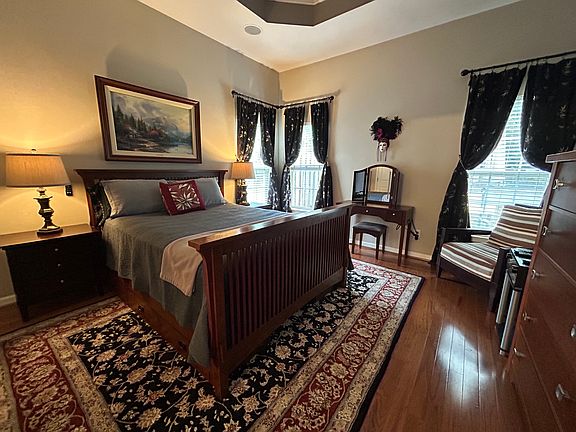 Master bedroom with en suite bathroom, tray ceiling and walk in closet.