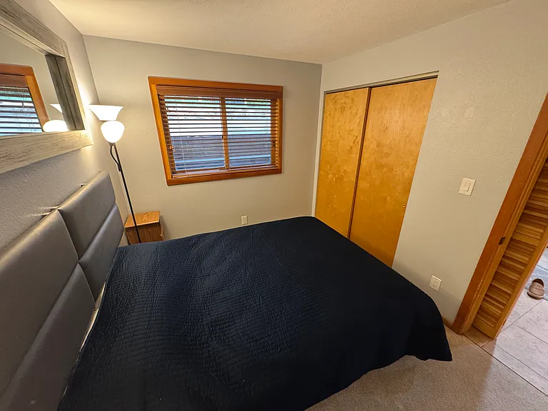 Guest room with queen bed and closet
