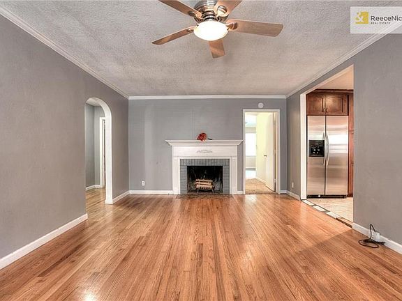 The wood-burning fireplace in the living room.  The door to the left is 3 bedrooms, 2 full  baths.  The door next to the fireplace is the Master Suite.  To the right is the kitchen.