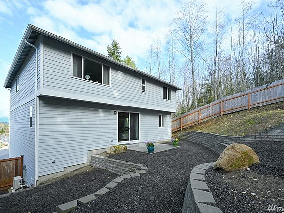 This backyard has a nice patio area with another area above that could be perfect for your firepit.