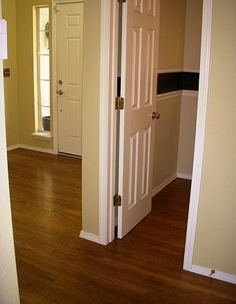 Harwood flooring in the foyer and hallway to Powder room
