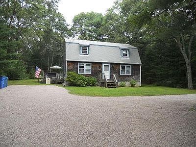 Front view, home sits privately back off the road
