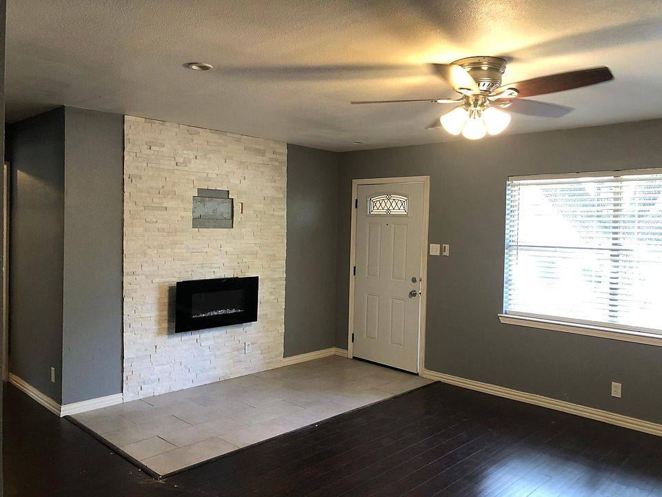 Entry with electric fire place and rock and wood finishes