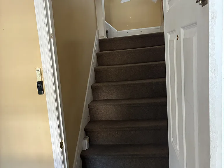 Stairs up from foyer to unit 2