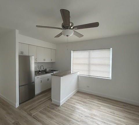 kitchen with stainless steel refrigerator and super expensive granite countertops