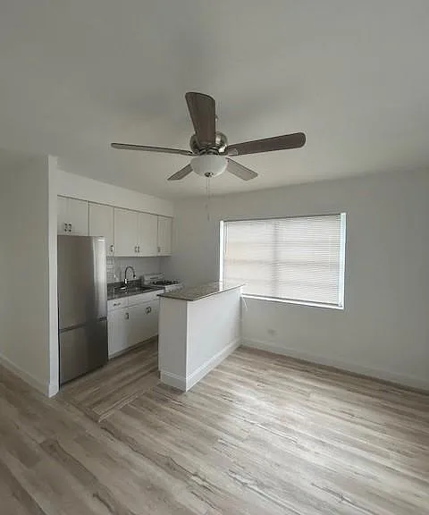 kitchen with stainless steel refrigerator and super expensive granite countertops