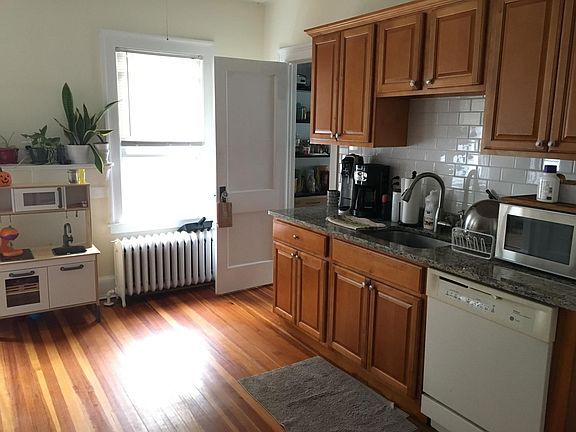 Kitchen with walk in pantry pictured in back corner of photo