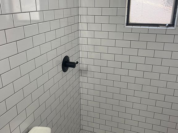 Subway tile bathroom with penny tile. Bathroom is all new with all new tile, toilet, walk-in shower and vanity.