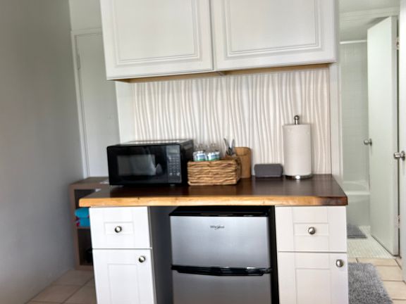 Meal Prep Area. Cabinets hold dishes,pots, pans, utensils, Toaster, Air Fryer, Coffee maker.