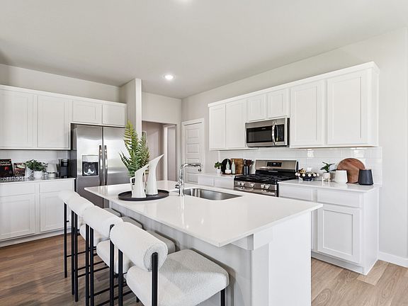 Kitchen in the Magnolia home plan by Trophy Signature Homes - REPRESENTATIVE PHOTO