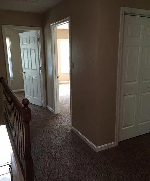 This photo is showing two bedroom doors and the linen closet.