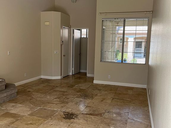Formal Living Room with high ceilings ; travertine tiles throughout; freshly painted
