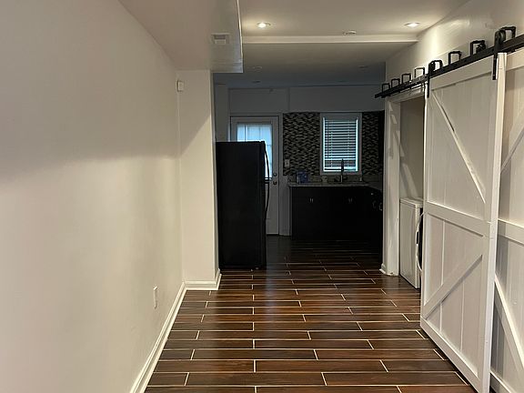 Living room to kitchen. Laundry behind doors