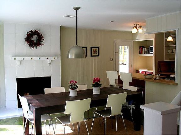 The dining room has a fireplace and looks into the front courtyard.