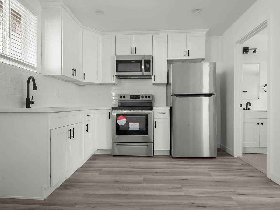 Kitchen - It includes Stainless steel Refrigerator, Stove, and Microwave.
