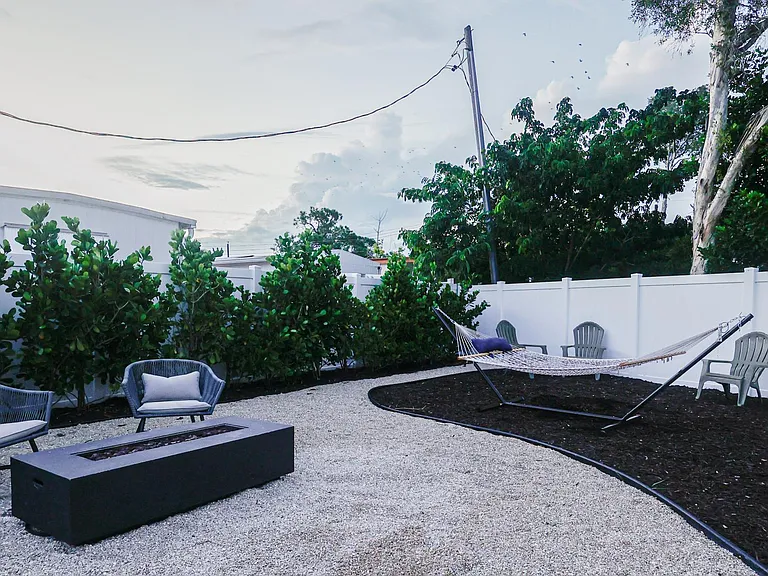Enjoy your private, spacious back yard with fire pit, hammock and dining area.