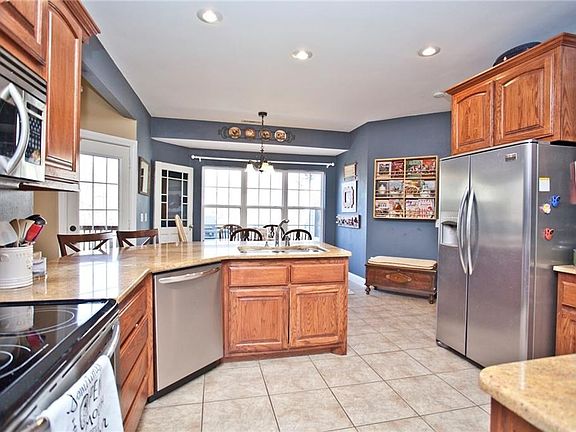 Living room to left, master suite to right, dining room directly behind, and breakfast nook directly ahead with door to large covered deck.
