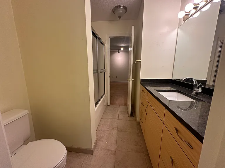 The upstairs bath is accessible from either front or back bedroom. Each has a vanity
