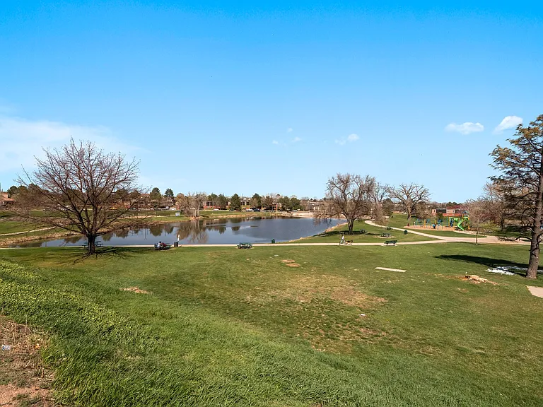 Park behind the condos with lake and playground trail connects to city of Denver