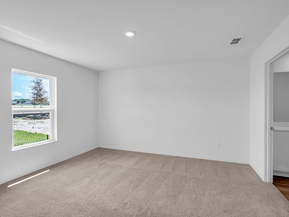 This spacious master bedroom is the perfect place to relax after a long day
