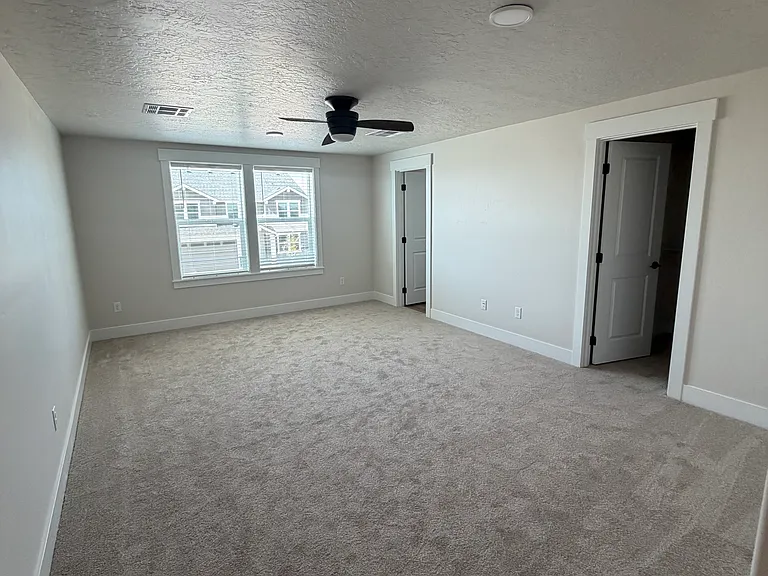 The upstairs primary suite offers a private and spacious retreat, complete with a large walk-in closet and a full en-suite bathroom. Thoughtfully designed for comfort and convenience.