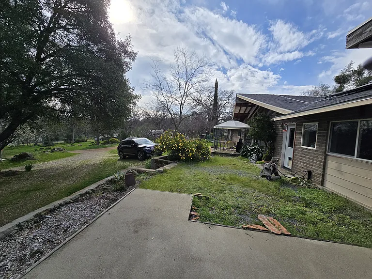 Looking south from Studio patio to house main entrance. Kitchen windows and door to the right side of photo.
