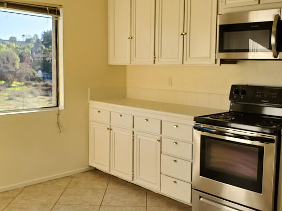Bright eat-in kitchen with lots of storage and views of the back and private garden atrium.