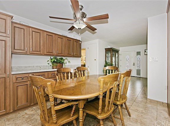 Kitchen eating area with more cabinets and serving counter.  There are lights under the cabinets.