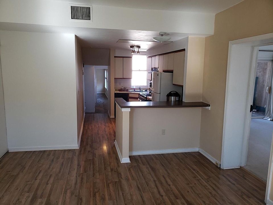 LR with breakfast bar and door to balcony BR