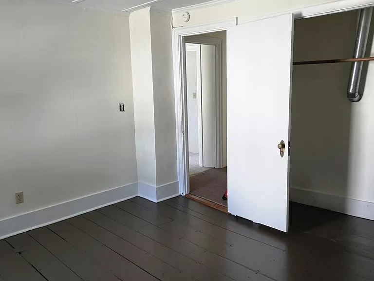 Master Bedroom With Wide Pine Flooring And Closet