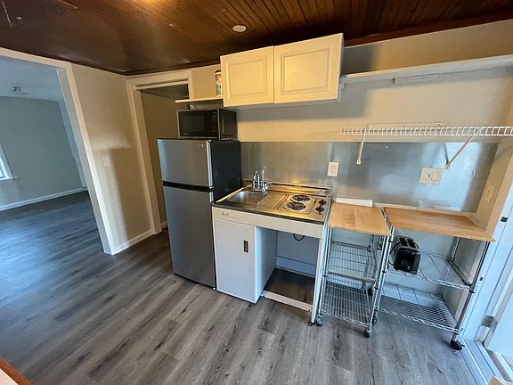 Kitchenette with two burner hot plate and sink. New stainless steal fridge and Microwave.
