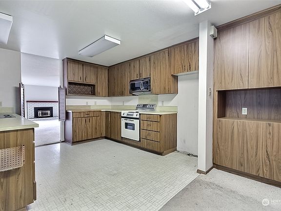 View from eat-in kitchen area to dining and living rooms.>